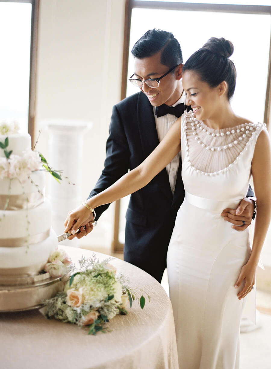 bride and groom cutting wedding cake