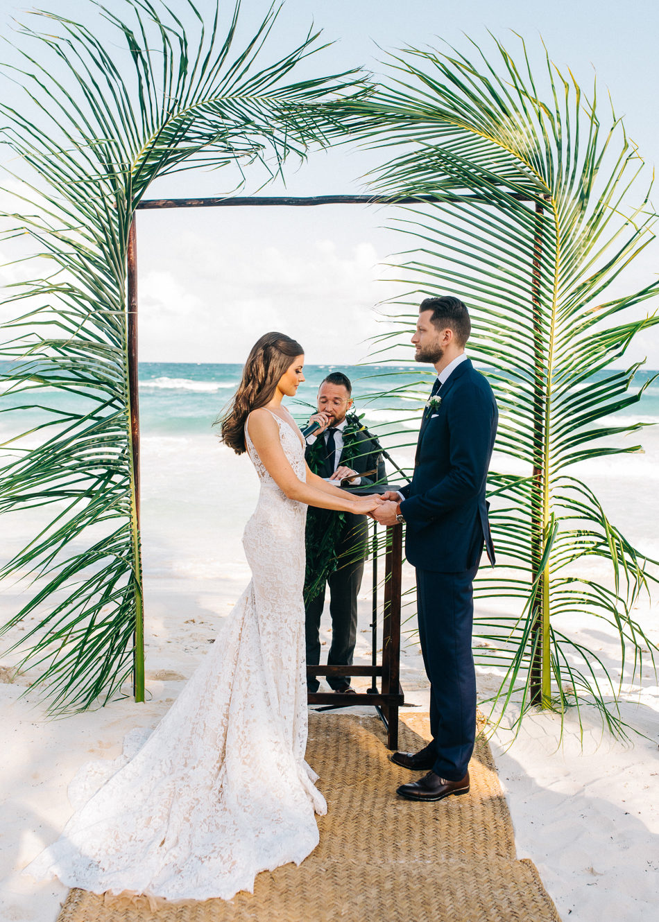 Bride and groom holding hands at altar