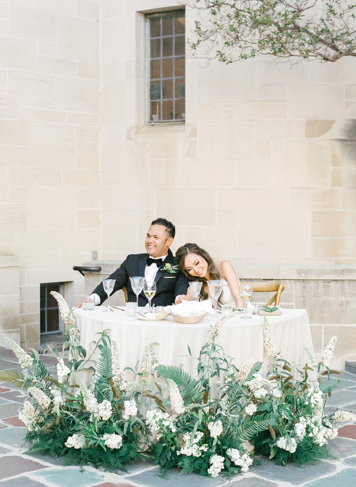 bride and groom sitting at table