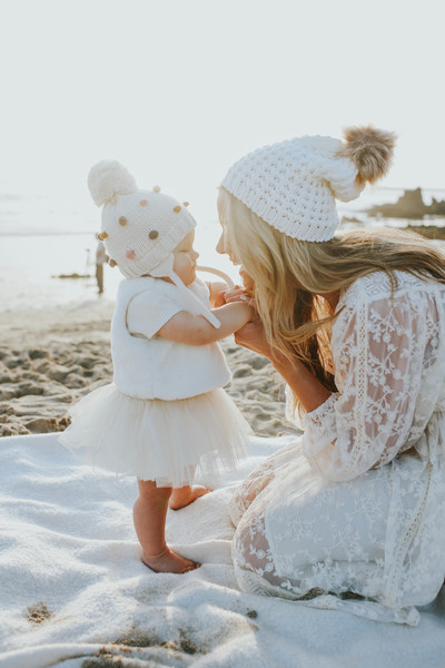 Mother smiling with baby on the beach
