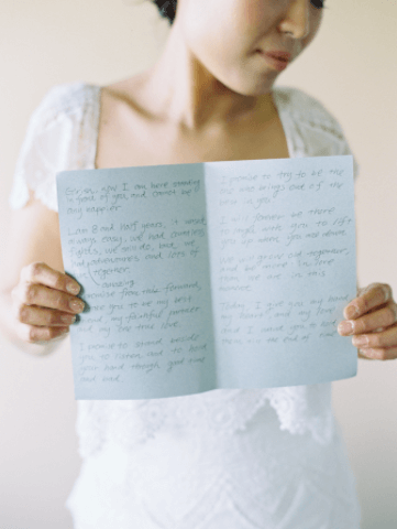 bride holding written wedding vows