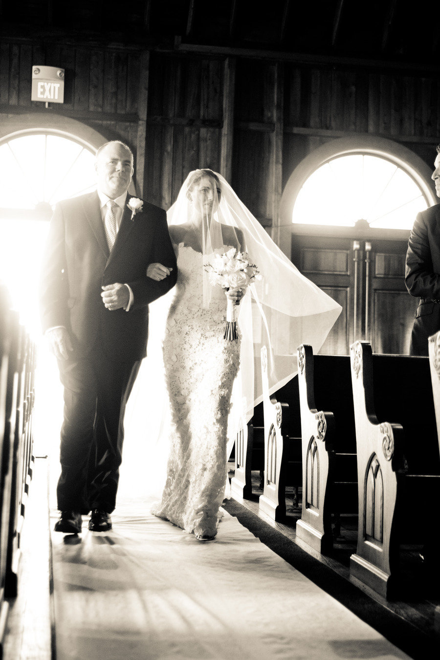 bride and father of bride walking down wedding aisle