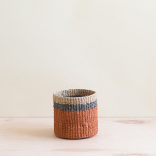 This is a orange accent pieces by LIKHA called coral cylinder tabletop basket in standard