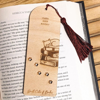 This is a natural back to school supplies by Samantha Malvey called cats and books bookmark | book lover gift in standard