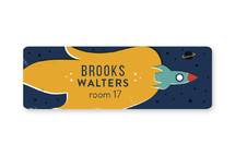 This is a blue name label by Kelsey Cashman called Rocket Blast Off with standard printing on waterproof sticker paper in sticker.