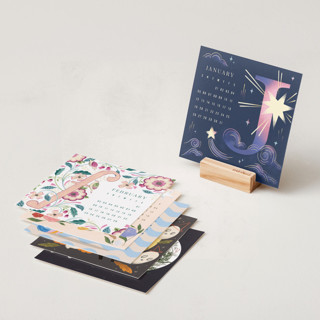 This is a festive photo calendars by Multiple Artists called artful letters: 2025 desk calendar in desk