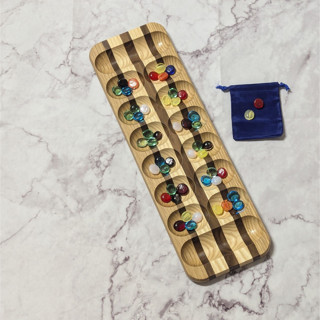 This is a natural home decor by Stacee Holtby called handmade mancala-african stone game in standard