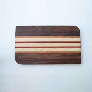 This is a pink tableware by Block and Bowl called cutting board in standard