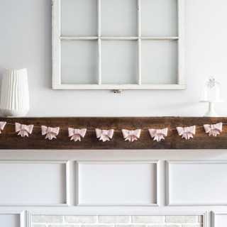 This is a pink holiday decorations by Nivas Collection called bow garland (blush, 6 feet) in standard