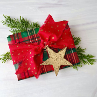This is a red holiday decorations by Honey Silks Co called star cotton ribbon and gold leaf star set in standard