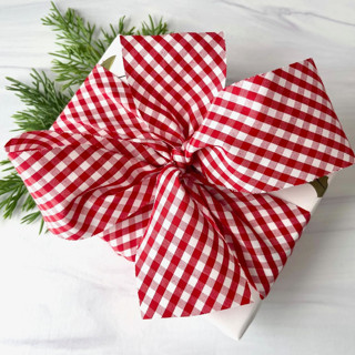 This is a red holiday decorations by Honey Silks Co called mini gingham check holiday ribbon in standard