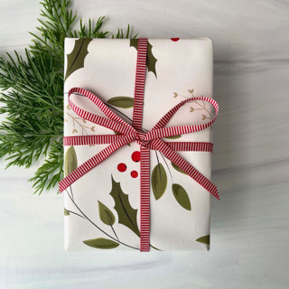 This is a red holiday decorations by Honey Silks Co called 1/4" x 15 feet vertical stripe holiday ribbon in standard