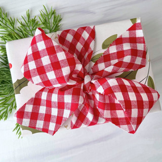 This is a red holiday decorations by Honey Silks Co called gingham check holiday ribbon in standard