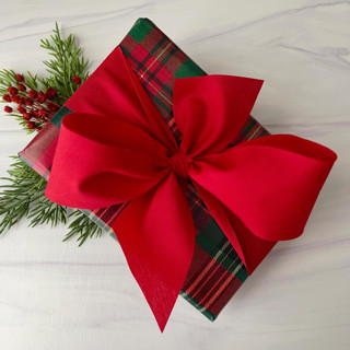 This is a red holiday decorations by Honey Silks Co called red 2" x 15 ft holiday ribbon in standard