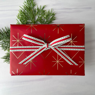 This is a red holiday decorations by Honey Silks Co called 3/8" red and green stitch holiday ribbon in standard