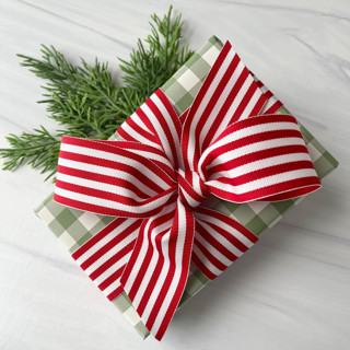 This is a red holiday decorations by Honey Silks Co called red stripe 1.5" x 15 ft holiday ribbon in standard
