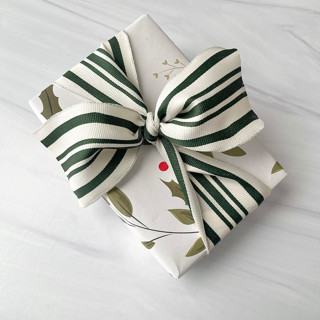 This is a green holiday decorations by Honey Silks Co called 1.5" green cotton striped ribbon - 5 yards in standard