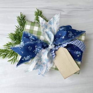 This is a blue holiday decorations by Honey Silks Co called cottage christmas ribbon set in blue in standard
