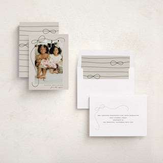 This is a putty holiday photo cards with standard by Lauren Chism called cascading bow printing on recycled smooth signature in standard