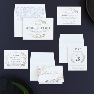 This is a classic white foil stamped wedding invitations with foil pressed by Kelly Schmidt called gilded leaves printing on signature in standard