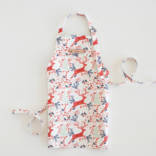 This is a red kids aprons by Phrosné Barwood called jumping reindeer in standard