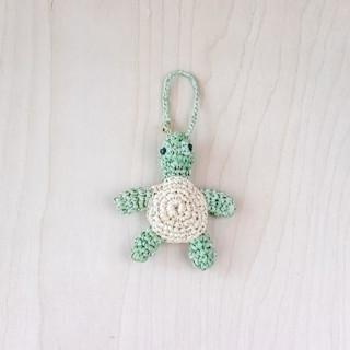 This is a green back to school supplies by LIKHA called turtle bag charm in standard