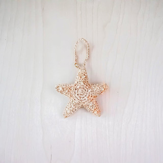 This is a natural back to school supplies by LIKHA called starfish bag charm in standard