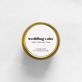 This is a gold bridesmaid gifts by Aria Bella Candles called wedding cake soy candle | gold travel tin in standard