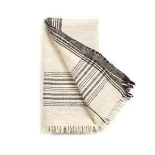 This is a white throw blankets by Anjali Purohit called seytu undyed black & white artisanal stripes handloom merino cotton soft blend throw in standard