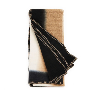 This is a brown throw blankets by Anjali Purohit called siro brown and white ombre textured throw  in hand spun merino and hand stitched hem in standard