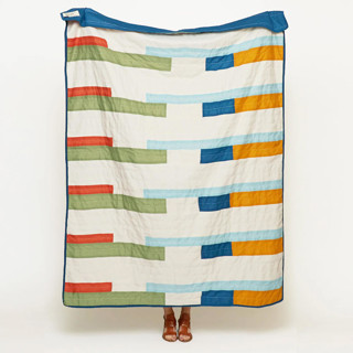 This is a multicolor throw blankets by Anchal called stamp quilt throw in standard