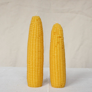This is a yellow candles and candle holders by Happy Organics called sweet maiz - corn beeswax candle set in standard