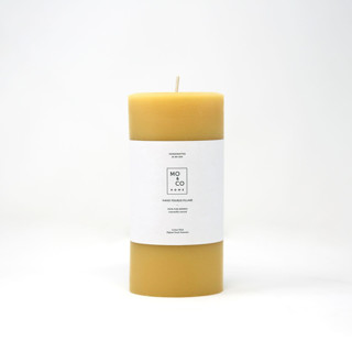 This is a gold candles and candle holders by MoAndCo Home called 3x6 inch, natural gold, beeswax pillar candle in standard