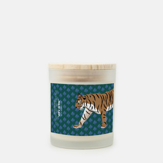 This is a green candles and candle holders by Clairebella called glass candle - flora tiger (spiced oatmilk) in standard
