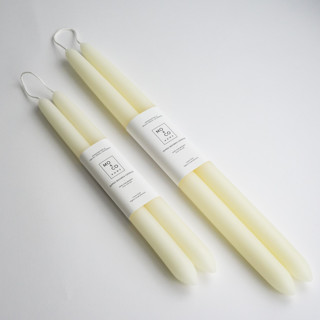 This is a white candles and candle holders by MoAndCo Home called 10 inch, natural white, dipped beeswax taper candles in standard