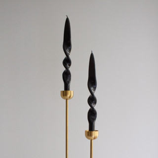 This is a black candles and candle holder by the parmatile shop called Taper Candle Set (SMOKE).