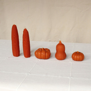 This is a orange candles and candle holders by Happy Organics called maple leaf - harvest table bundle beeswax candles in standard