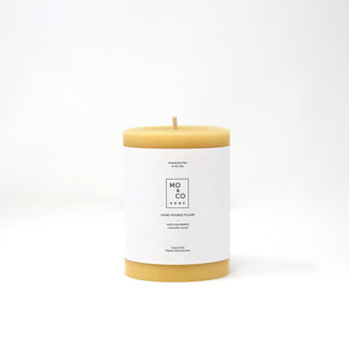 This is a gold candles and candle holders by MoAndCo Home called 3x4 inch, natural gold, beeswax pillar candle in standard