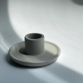 This is a natural candles and candle holders by Powered By People called concrete candle holder in standard