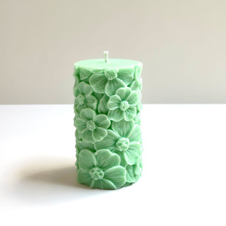 This is a green candles and candle holders by Over By The Moon called green floral pillar in standard