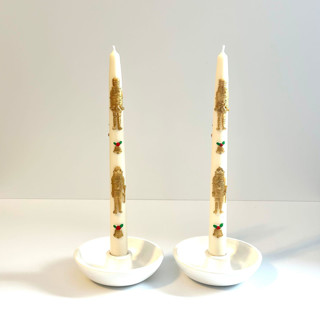 This is a multicolor candles and candle holders by Over By The Moon called white and gold nutcracker tapers in standard