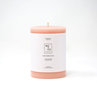 This is a pink candles and candle holders by MoAndCo Home called 3x4 inch, pink rose, beeswax pillar candle in standard