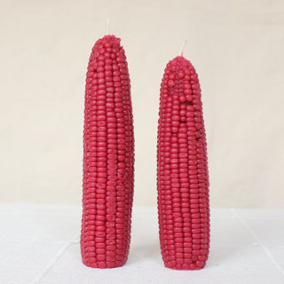 This is a red candles and candle holders by Happy Organics called pomegranate - corn beeswax candle set in standard