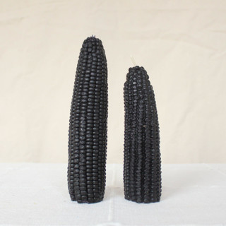 This is a black candles and candle holders by Happy Organics called blackberry - corn beeswax candle set in standard