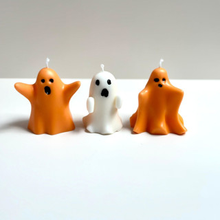 This is a multicolor candles and candle holders by Over By The Moon called orange and white ghost candle set in standard