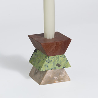 This is a green candles and candle holders by Powered By People called triangle puzzle and stackable candelabra in standard