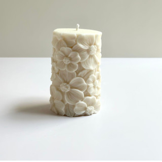 This is a white candles and candle holders by Over By The Moon called white floral pillar in standard