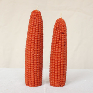 This is a orange candles and candle holders by Happy Organics called maple leaf - corn beeswax candle set in standard