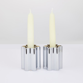 This is a silver candles and candle holders by Leadoff Studio called candle holders - chrome in standard