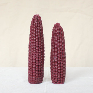 This is a purple candles and candle holders by Happy Organics called mulberry - corn beeswax candle set in standard
